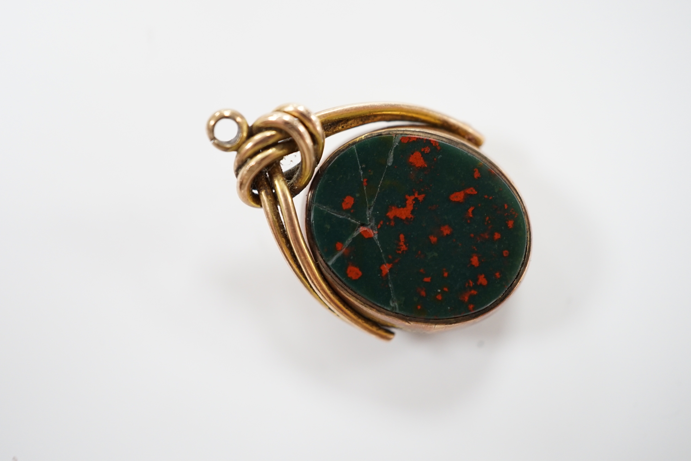 An early Victorian yellow metal and seed pearl set mourning brooch, with plaited hair, 23mm, together with two chalcedony set fob seals, including 9ct gold mounted.